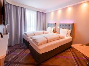 a hotel room with two beds in a room at Premier Inn Mannheim City Centre in Mannheim +16 photos