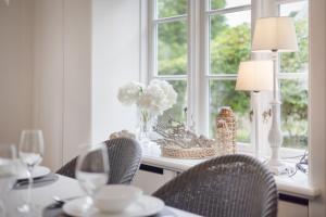 a dining room table with chairs and a window at Seepferdchen in Keitum +25 photos