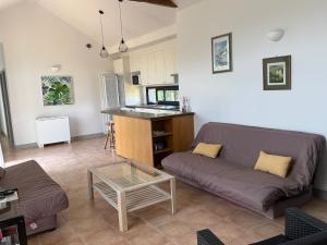 a living room with a couch and a table at Orangerie in Benais