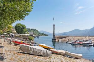 a group of boats on the shore of a body of water at Appartamento Isabella in Verbania