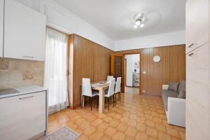 a kitchen and dining room with a table and chairs at Appartamento Isabella in Verbania +16 photos