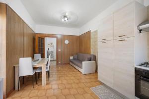 a kitchen and dining room with a table and a couch at Appartamento Isabella in Verbania