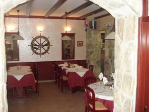 a restaurant with two tables with red and white table cloth at Pansion Marco Polo in Petrcane