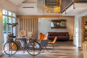 a bike parked in a living room with a table at Sure Hotel by Best Western Angers Sud in Les Ponts-de-Cé