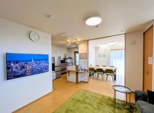 a living room with a kitchen and a dining room at Frog Inn - Entire House for Private Use in Fujinomiya
