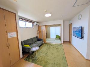 a living room with a couch and a window at Frog Inn - Entire House for Private Use in Fujinomiya