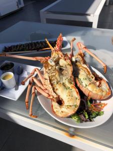 a plate of food with lobster on a table at Hôtel Baie des Anges in Gustavia