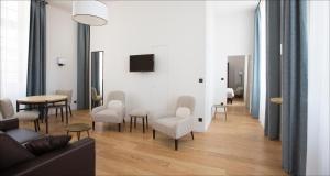 a living room with a couch and chairs and a table at Hotel College des Doctrinaires, BW Premier Collection in Lectoure