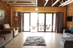 a living room with a couch and a table at Hide Away Wedding,Conference & Function Venue in Bela-Bela
