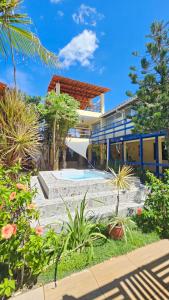 a house with a swimming pool in front of it at Shanti Om Refúgio Pousada e Yoga in Cascavel