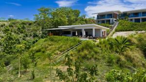 a house on top of a hill with trees at Solindo Suite in Marbella