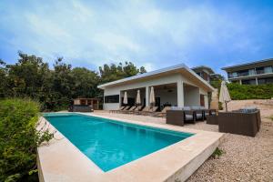 a swimming pool in front of a house at Solindo Suite in Marbella