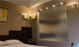 a bedroom with a large mirror on the wall at Hotel Css in Ituzaingó