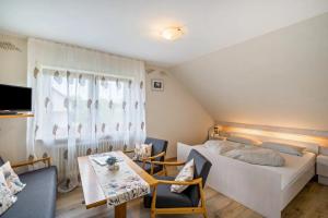 a bedroom with a bed and a table and chairs at Apartment Abendrot in Freiamt
