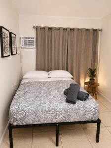 a bed with two pillows on it in a bedroom at Fauna Beach in Gold Coast Heliport