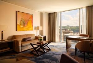 a living room with a couch and a large window at Fairmont Pittsburgh in Pittsburgh