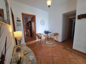 a living room with a table and two chairs at Casa Rural El Pergareo in Cazalla de la Sierra