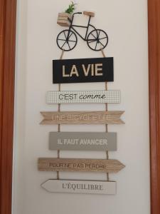 a shelf with a bike on top of signs at Casa Rural El Pergareo in Cazalla de la Sierra