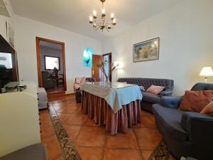 a living room with a table and a couch at Casa Rural El Pergareo in Cazalla de la Sierra