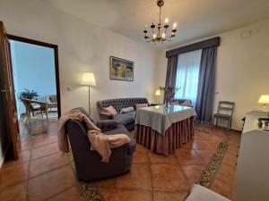 a living room with a couch and a table at Casa Rural El Pergareo in Cazalla de la Sierra +25 photos