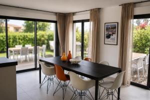 a dining room with a black table and chairs at VillaGassin 380 Luxury Villa with Private Pool near Saint-Tropez - Airco-Parking in Saint-Tropez