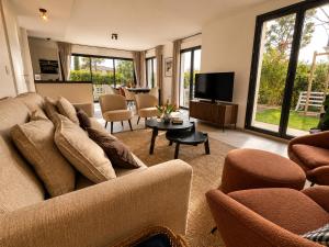 a living room with a couch and a television at VillaGassin 380 Luxury Villa with Private Pool near Saint-Tropez - Airco-Parking in Saint-Tropez
