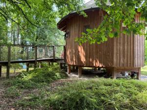 a wooden out house with a wooden bridge at Le P’tiot Utau in Chapelle-Voland