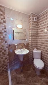 a bathroom with a toilet and a sink at Akrotiria Beach Apart Complex in Nesebar +136 photos
