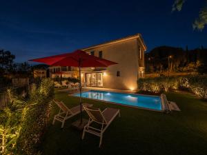 a house with a pool and two chairs and an umbrella at VillaGassin 380 Luxury Villa with Private Pool near Saint-Tropez - Airco-Parking in Saint-Tropez