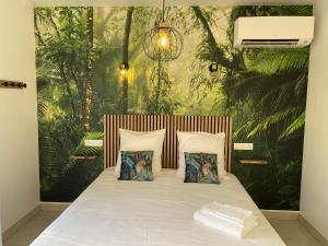a bedroom with a large bed with two pillows at La Maison Blanche 1 in Bouguenais