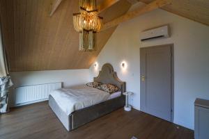 a bedroom with a bed and a chandelier at Velur Haus in Borne Sulinowo