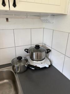 two pots and pans sitting on top of a kitchen counter at Övertun in Hamburgsund +8 photos
