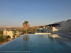 a large swimming pool in front of a house at Kefalos View in Vrachonisída Palaiókastro