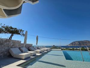 a villa with a pool and a view of the ocean at Kefalos View in Vrachonisída Palaiókastro