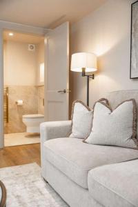 a living room with a couch and a bathroom at The Annexe in Cobham