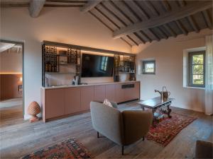a living room with a couch and a tv at Tenuta Bartoli in San Gimignano