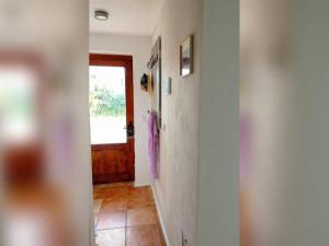 a hallway with a door and a room with a tile floor at Ferienbungalow Haus Rolf _ Objekt in Papendorf