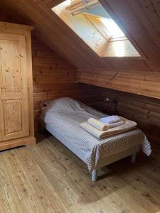 a bedroom with a bed in a wooden attic at Chalet airelles in Saint-Pierre