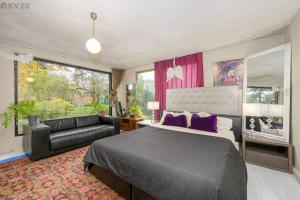 a bedroom with a large bed and a couch at Zen Garden House in Võduvere