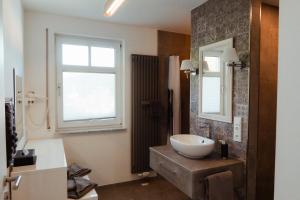 a bathroom with a sink and a mirror at Schlossberghotel Greiz in Greiz +55 photos