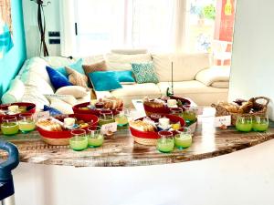 a table with several baskets of food on it at Red House Rooms in Llucmajor