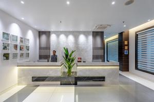 a man sitting at a counter in a lobby at ECONEST HOTEL in Tarapith +37 photos