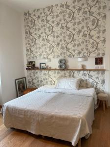 a bedroom with a bed with a floral wallpaper at BnB Centro Centro in Ascoli Piceno