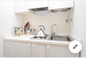 a kitchen sink with a tea kettle on it at BnB Centro Centro in Ascoli Piceno
