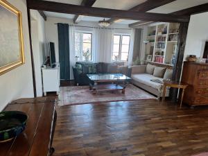 a living room with a couch and a coffee table at Klockargården Örja byväg 17 in Landskrona