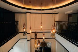 a room with chandeliers hanging from a ceiling at Selah Hanoi Hotel in Hanoi +41 photos