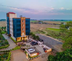 an aerial view of a building with a parking lot at ECONEST HOTEL in Tarapith