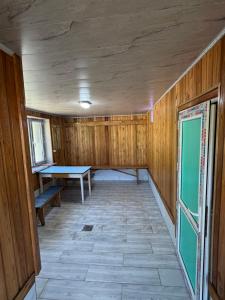 an empty room with a ping pong table in it at Bakytzhan hotel in Kurmenty