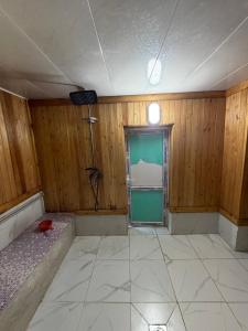 an empty room with a door and a window at Bakytzhan hotel in Kurmenty +9 photos