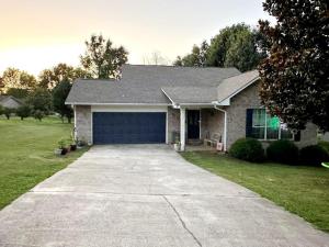 a house with a large garage in the driveway at Be our Guest in Sevierville